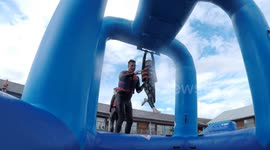 6 year old does Monkey bars at water assault course