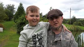 Boy, seven, born without arm holds fishing rod in two hands for the first time