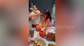 Little girl blows out birthday cake before candle sets fire to her hair