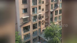 Neighbour climbs through building window to save trapped child in China