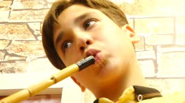 Palestinian child Bashir Al-Ayoubi 13, plays on flute at the studio in Gaza city