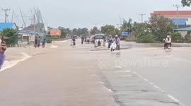 Villagers wade through flood as heavy rains hit Cambodia