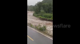 Moment road collapses as Typhoon Doksuri rains continue to lash Beijing