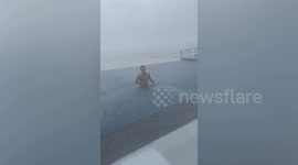 Lad swims in infinity pool during Super Typhoon Doksuri in the Philippines