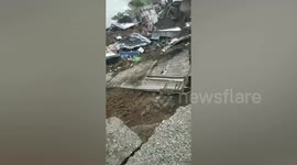 Dozens of homes plunge into swollen river eroded by bad weather in the Philippines