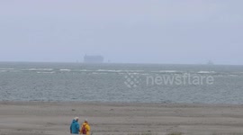 Burning ship carrying 3,000 cars towed to temporary location off Dutch coast