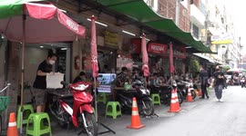 Cafe swerves ban on street tables by using boards fixed to motorcycles