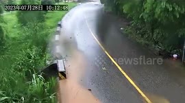 Landslide tumbles onto road amid heavy rain from Typhoon Doksuri in China