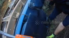 Firefighters extract passengers trapped in overturned car that fell into ditch in Alabama