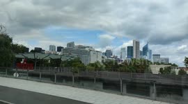 Panoramic travelling view on La Défense business district from the Pont de Puteaux bridge from a bus.  La Défense is a business district located in the Greater Paris metropolis in Île-de-France, the second most attractive business district in Europe, afte