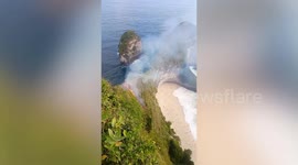 Dozens of tourists stranded when fire breaks out on cliff at Bali beach