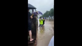 Police officer escorts infant to safety in rain-triggered flood in N China