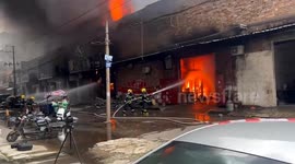 Heroic firefighters survive falling debris while handling blaze that engulfs clothing workshop in China