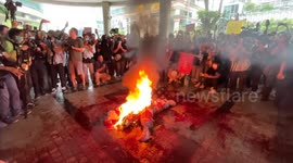 Protesters burn mock corpses outside former Man City owner's offices amid election anger