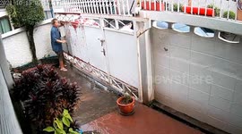 Sliding gate falls while old man tries to open it