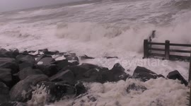 Waves and sea foam crash onto Camber coast as stormy conditions move in