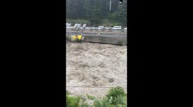 Car Swept Into River by Heavy Rainfall