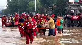 Rescue team battles to save hundreds stranded in flooded village due to heavy rain in China