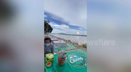 Storm slams into riverside while locals enjoy barbecue