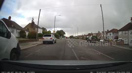 A Car driving at high speed overtakes a learner driver slowing down for a pedestrians on a zebra crossing