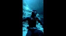 Diver Squeezes Through Underwater Tunnel