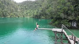 Tourist's idyllic swimming video fails when he slips on diving board