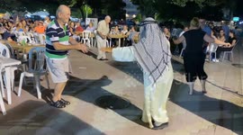 Arab tourist crashes Greek traditional feast while cut a dash on the dance floor