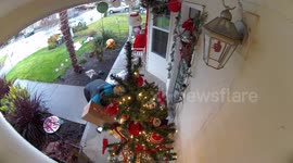 312003673 Delivery Driver Fixes Christmas Decorations After Storm