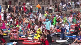 Thousands of costumed individuals take part in paddleboarding event in St Petersburg