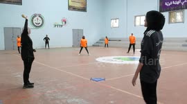 Palestinian female players of Al-Aqsa Sports Club , compete with players of Baseball Academy, during baseball match, in the Nuseirat refugee camp in the central Gaza Strip