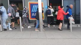 Storm Antoni, Shoppers and holiday makers struggle outside a supermarket in storm winds in the West Country, Newquay, Cornwall, UK