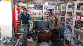 Axe-wielding robber in bizarre disguise caught on camera stealing cash from Indonesian store
