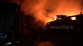 Firefighters attempt to extinguish blaze as missile strike decimates warehouse in west Ukraine
