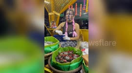 Food vendor wears colorful costume in Cambodia
