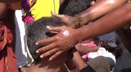 Bizarre ritual where devotees break coconuts on their heads were held in India