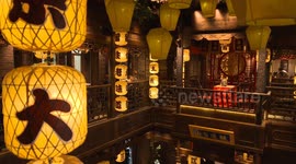 Diners at Nanjing Restaurant in Nanjing, Jiangsu Province, take pictures downstairs from the second floor of the restaurant