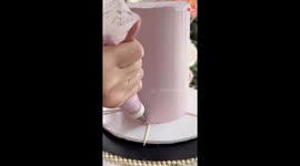 Cake Artist decorates a lavender haze cake by piping the frosting *Amazing Cake Art*