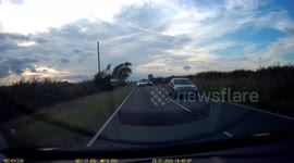 Close call as oncoming vehicle veers into wrong lane to overtake car