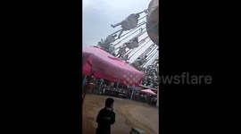 Terrifying moment woman faints on flying chair ride in eastern China