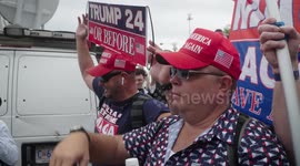 MAGA protestors watch as anti-Trump woman shouts over a megaphone during the 3rd Federal Indictment of Donald J. Trump