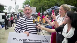 Protestor in striped prison suit says that MAGA supporters are zombies during the 3rd Federal Indictment