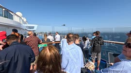 Passengers on Royal Caribbean cruise ship watch helicopter medivac crew member at sea