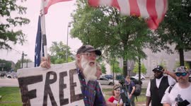 Trump Supporter  holds a Free J6rs sign for people indicted for the January 6th Insurrection during the 3rd Federal Indictment of Donald J. Trump