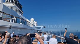 Passengers on Royal Caribbean cruise ship watch helicopter medivac crew member at sea