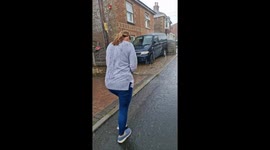 Wife gets wet walking back from the pub British summer rain storm