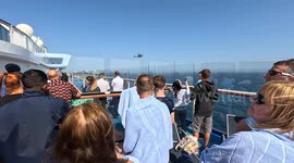 Dramatic helicopter rescue brings tourists' cruise to halt as ill crew member air-lifted from ship