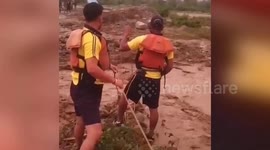 Rescue officials come to the aid of labourers stranded in flooded area in northern India