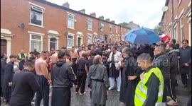Shia Muslim parade through a British street honouring the prophet Mohammed’s grandson