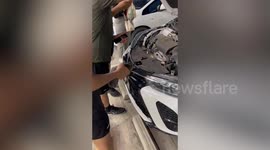 Kitten trapped in car engine at parking lot saved by kind passerby