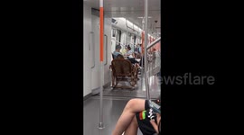 Old Man Enjoying His Special Chair in the Subway in Wuhan, Hubei, China